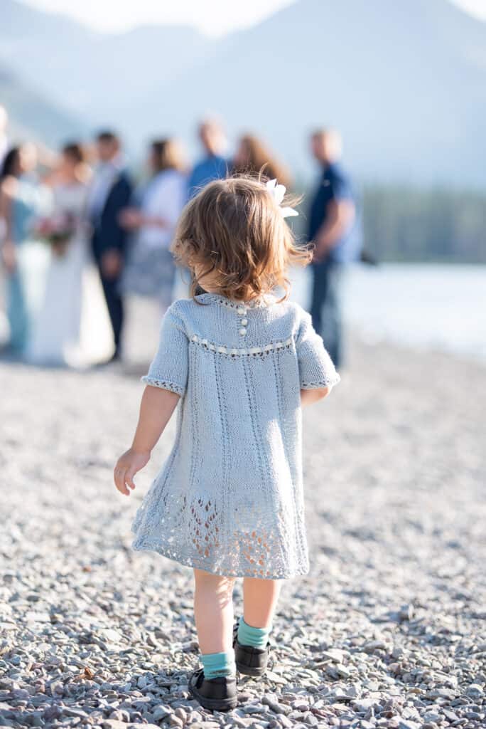 toddler on the beach at two medicine lake, glacier national park