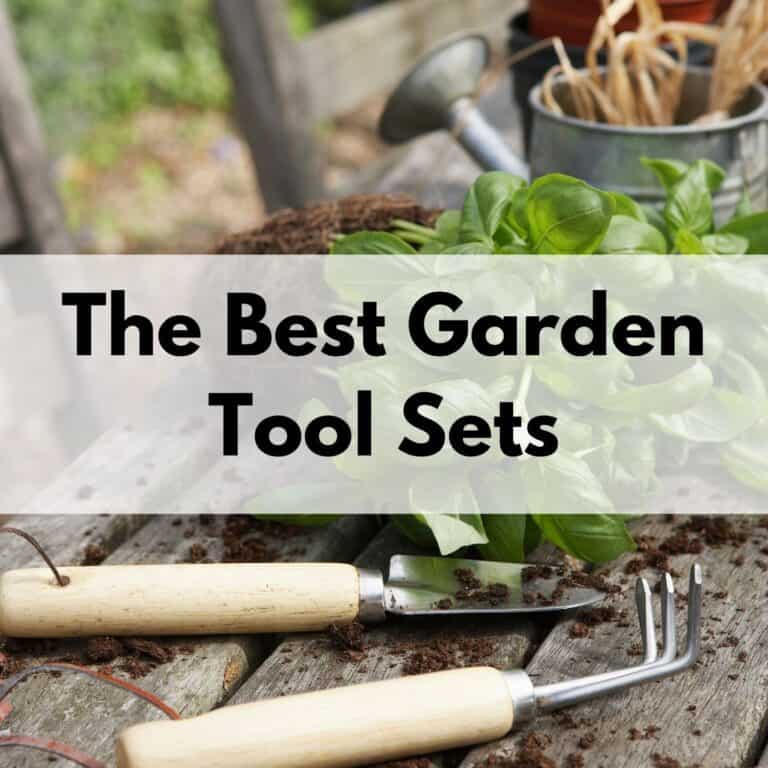 text overlay "the best garden tool sets" over a picture of a small trowel and hand cultivator on a wood table in front of a basil plant and metal watering can