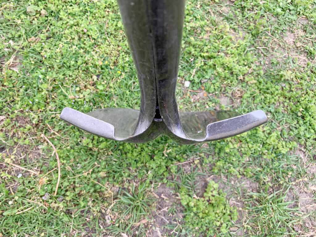 A close up top down view of a shovel with a rolled lip.