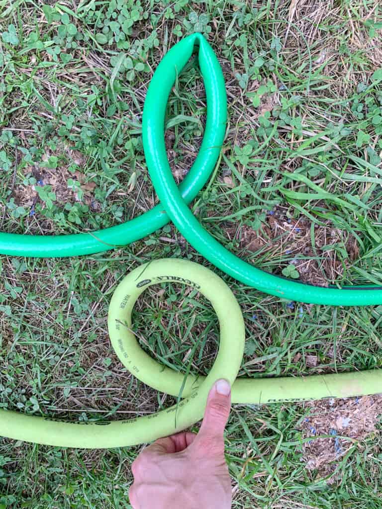 a flexzilla garden hose that is looped but not kinked with a "regular" garden hose that is kinked