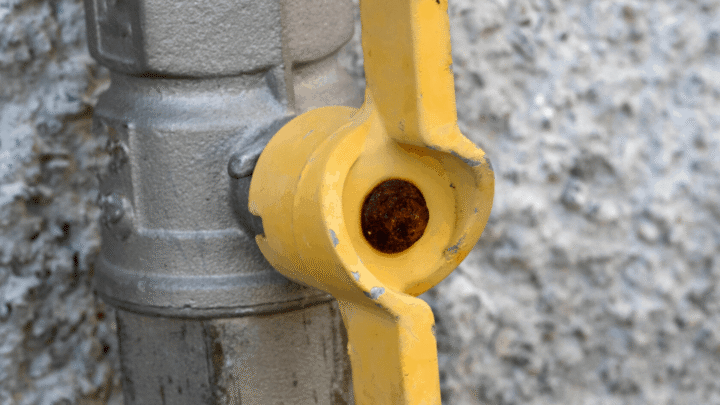 Text reads "the best hose shut-off valves for ultimate control." Photo is of a hose connected to a shut-off valve. The body of the valve is silver and the valve handle is yellow. The yellow handle is an inline handle and is on the open position.