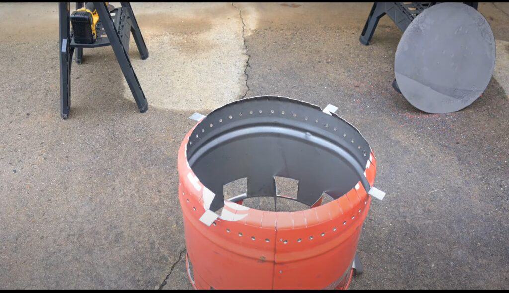 Photo is an inner barrel of a smokeless firepit with 4 tabs bent outward.