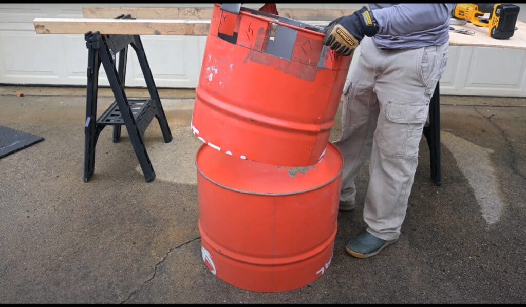 Photo is of a man placing one smaller barrel section on another barrel end to mark it.