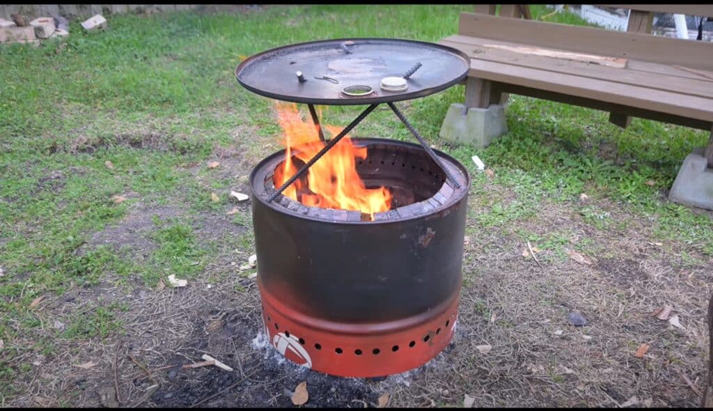 Photo is of a smokeless firepit made from a 55 gallon drum with a heat deflector.