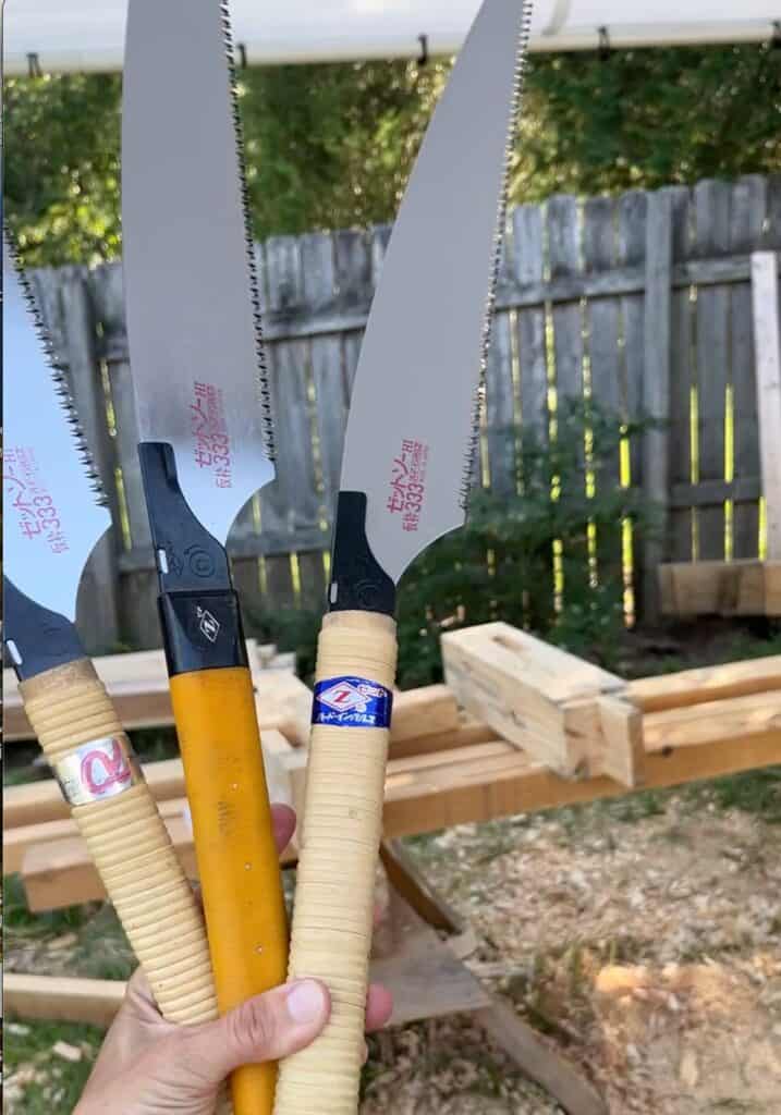 a hand holding three z saws