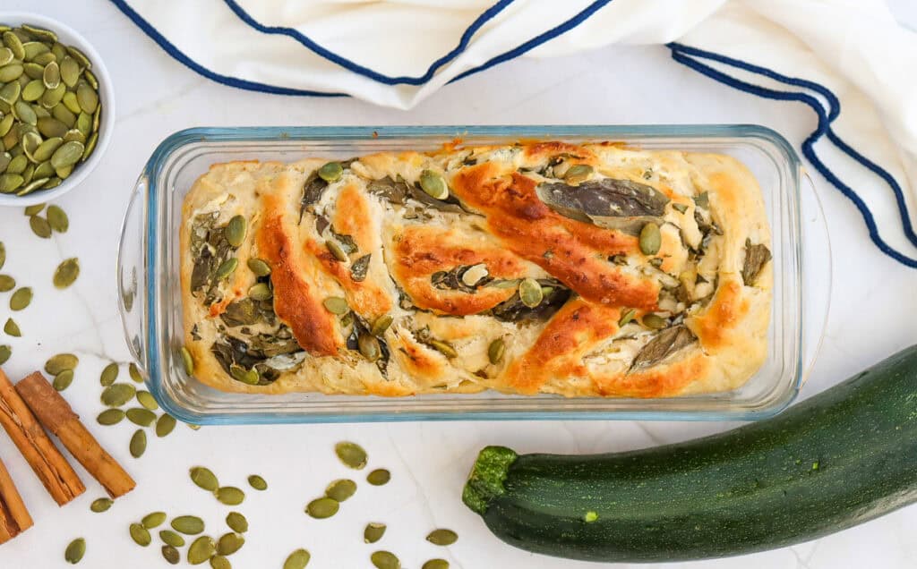 a baked loaf of zucchini swirl bread golden brown from the oen