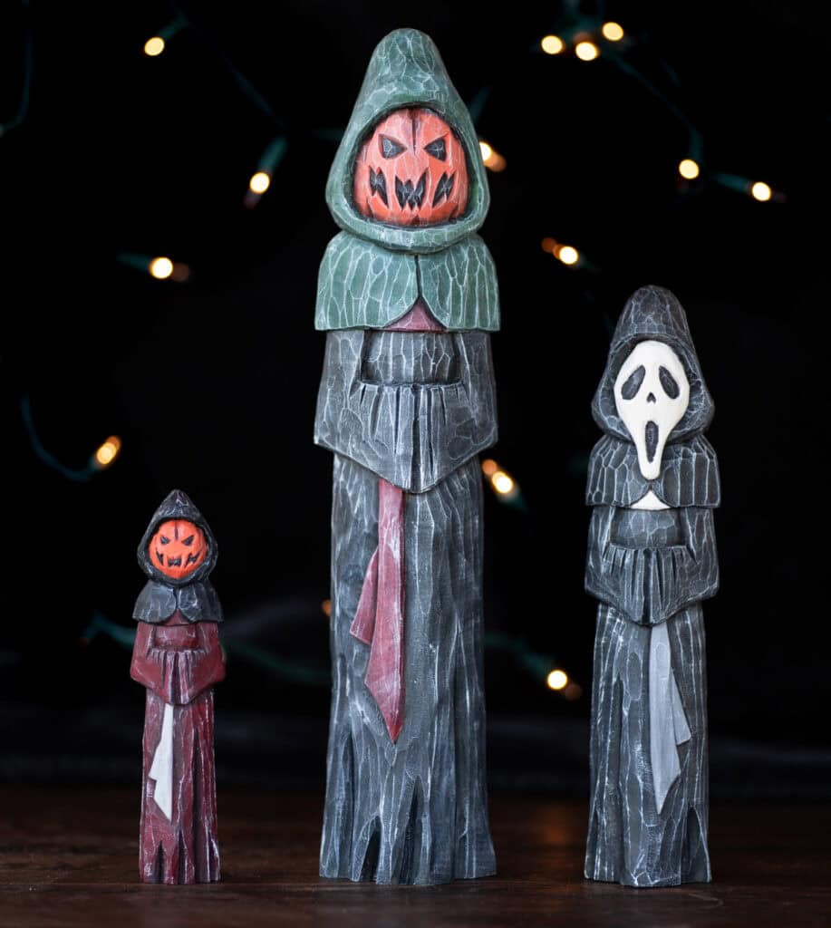 three spooky halloween carvings in robes
