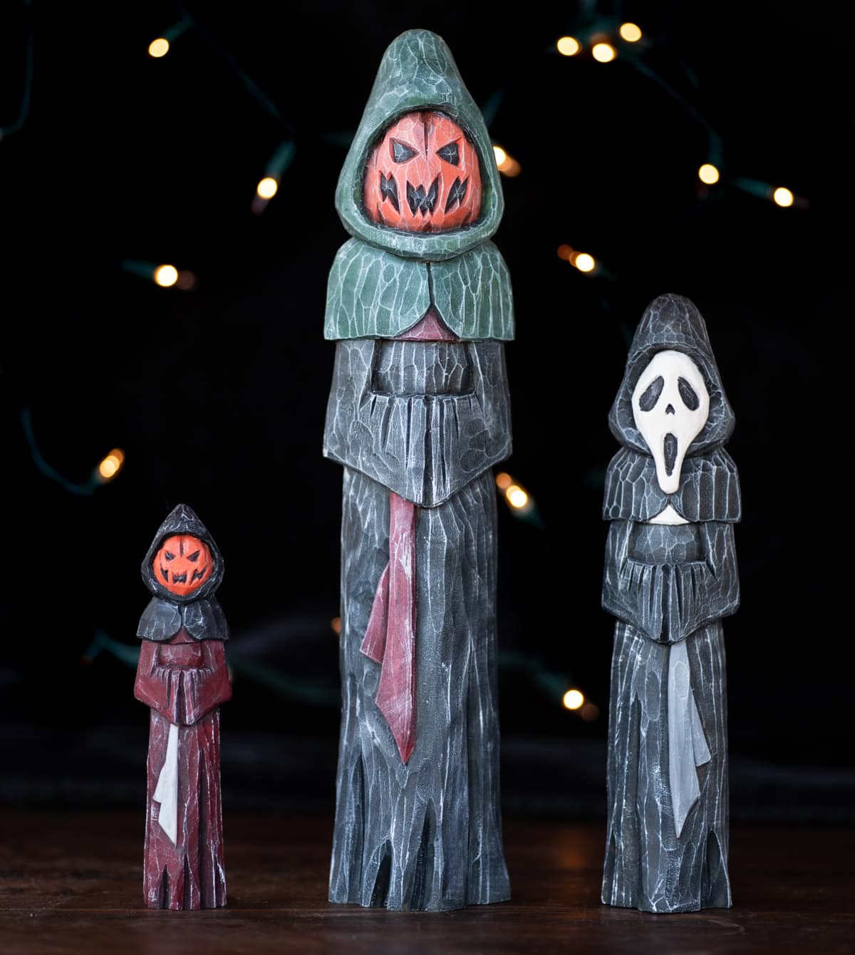 three spooky halloween carvings in robes