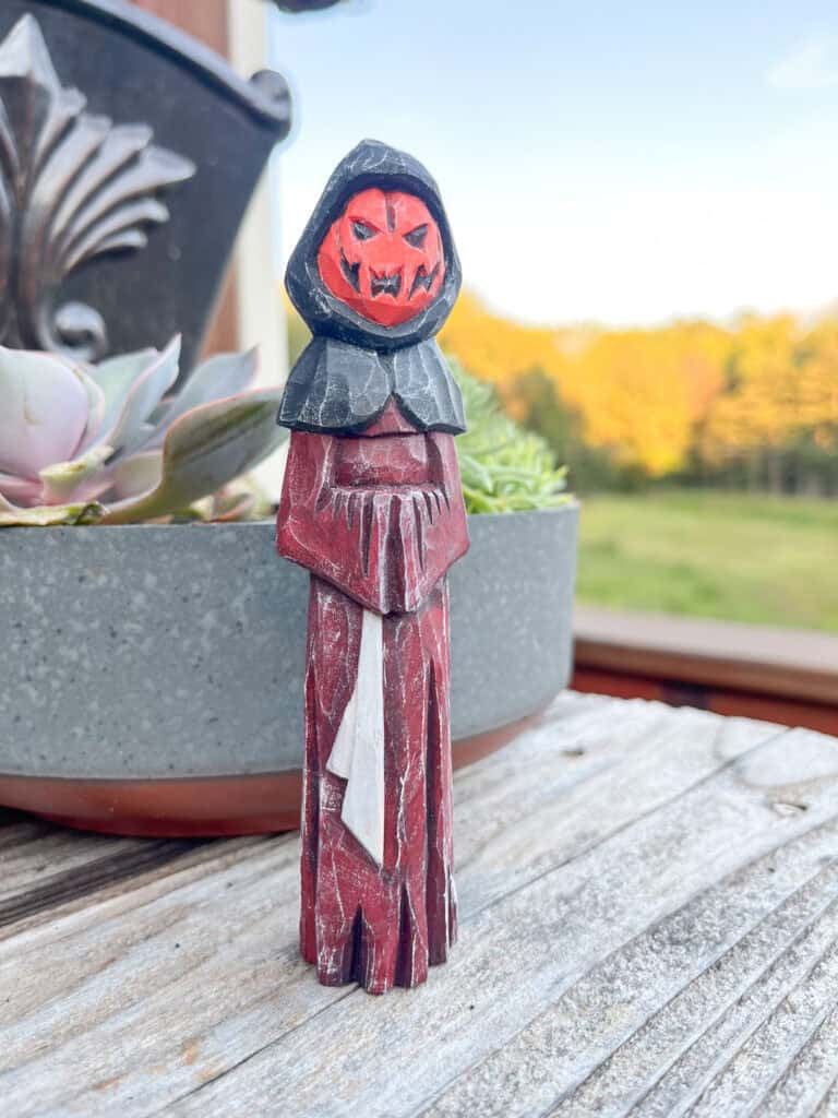 a painted carved wood figurine of a halloween figure
