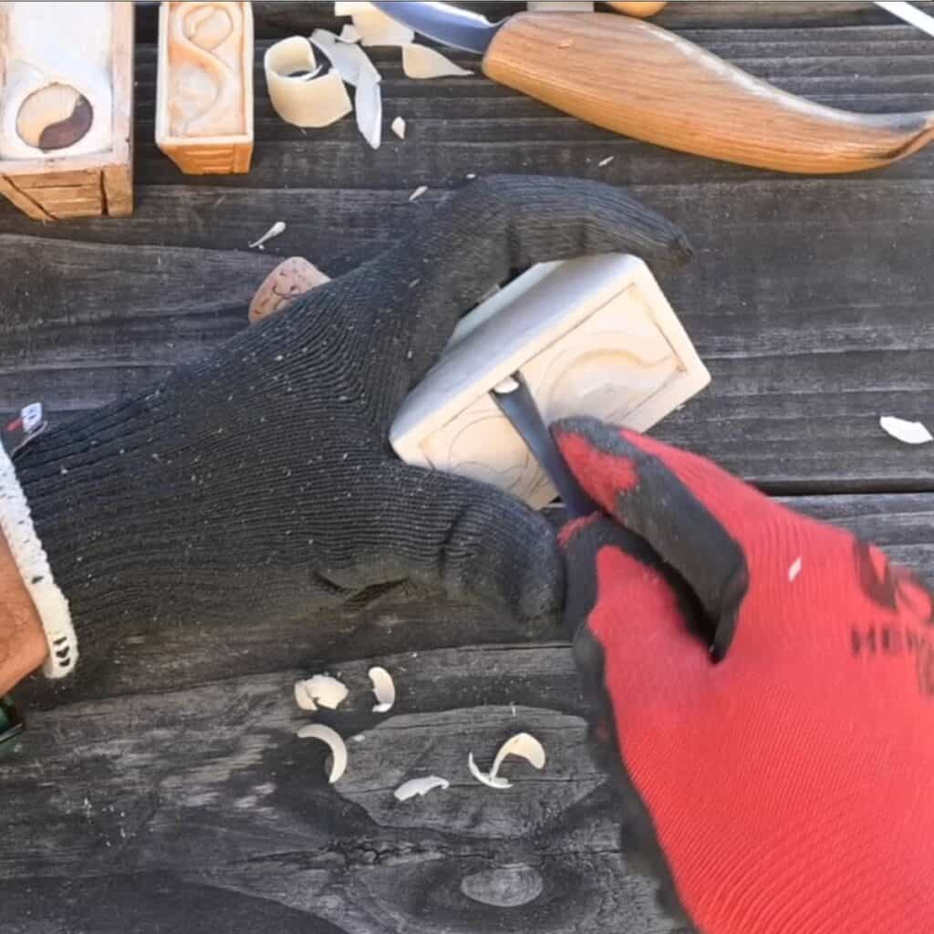 using a gouge to carve a wood manger