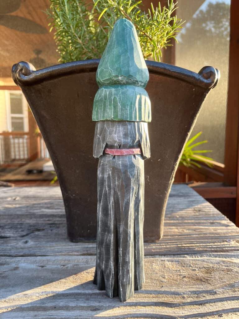 the back of a wood carved halloween figure