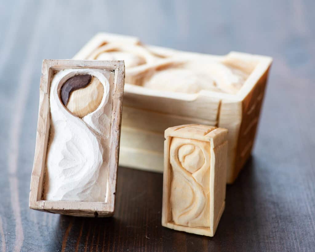 three wood carved mangers