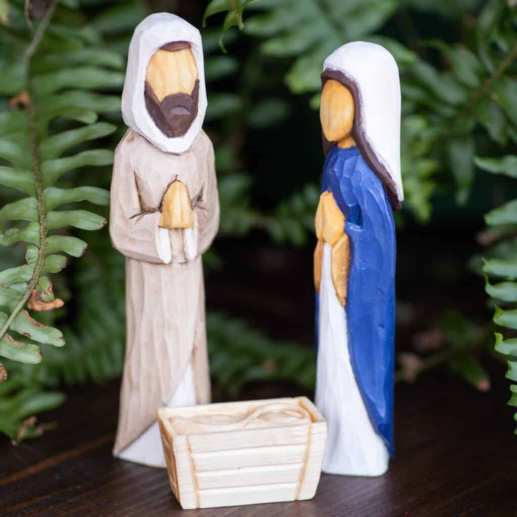 a hand carved wood three piece nativity set