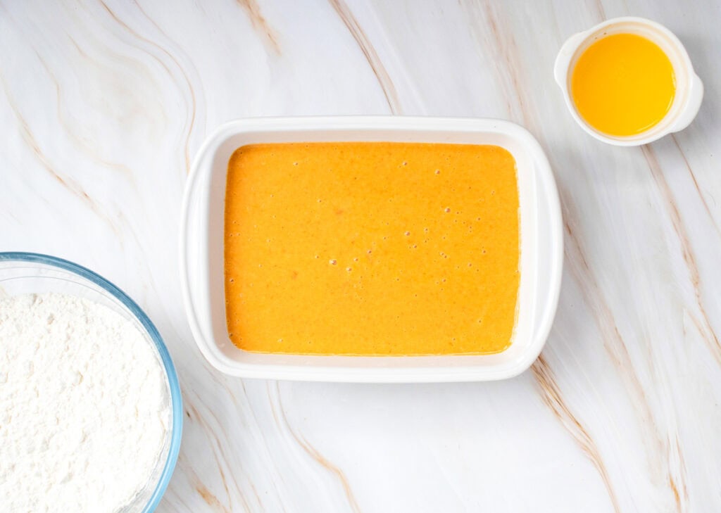 a 9x13 baking dish with a pumpkin puree mixture