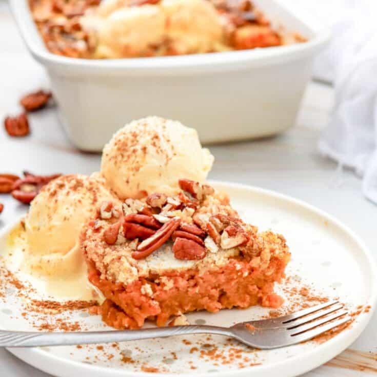 a piece of pumpkin dump cake with ice cream on top