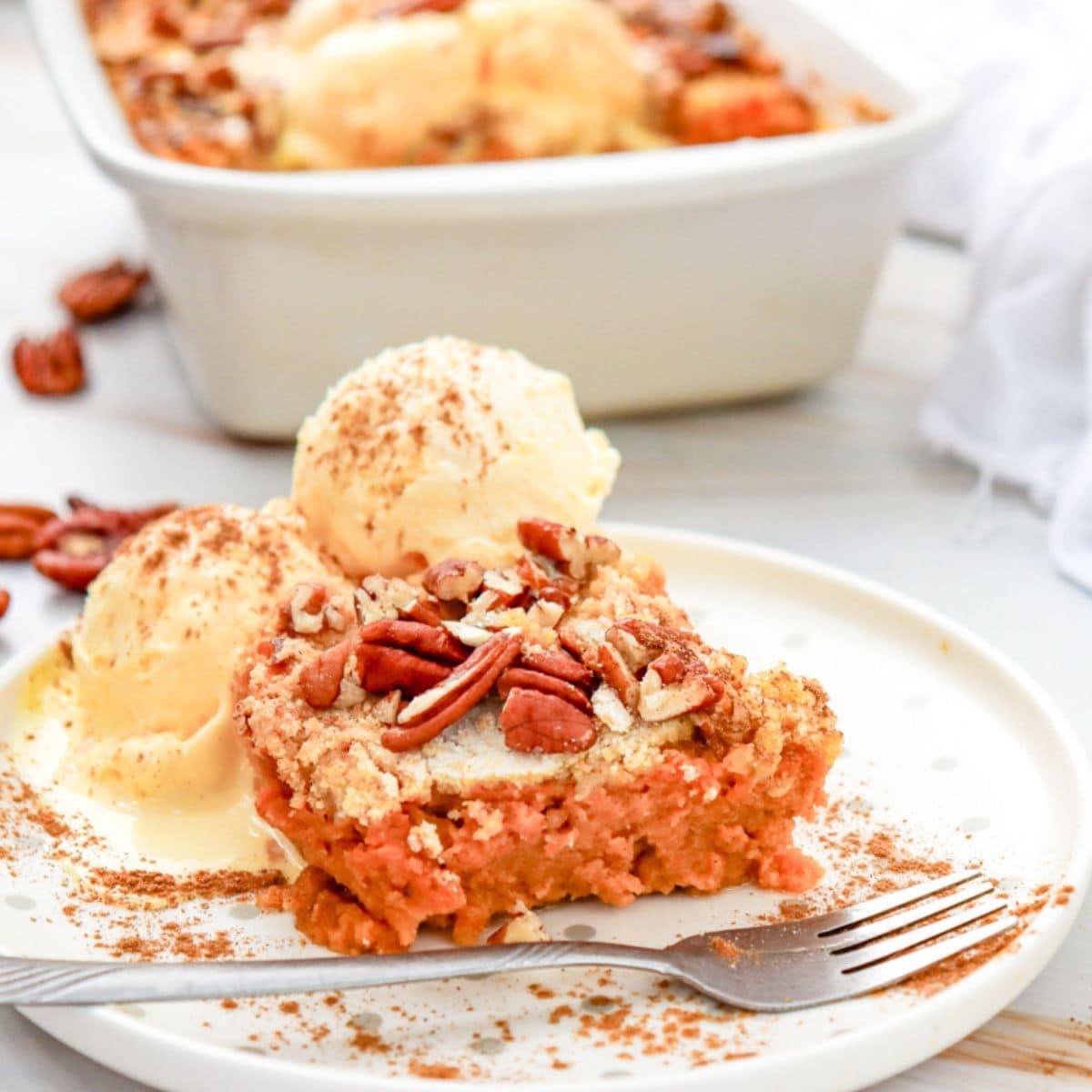 a piece of pumpkin dump cake with ice cream on top