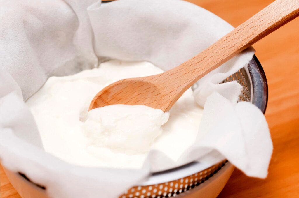 yogurt in cheesecloth in a collander