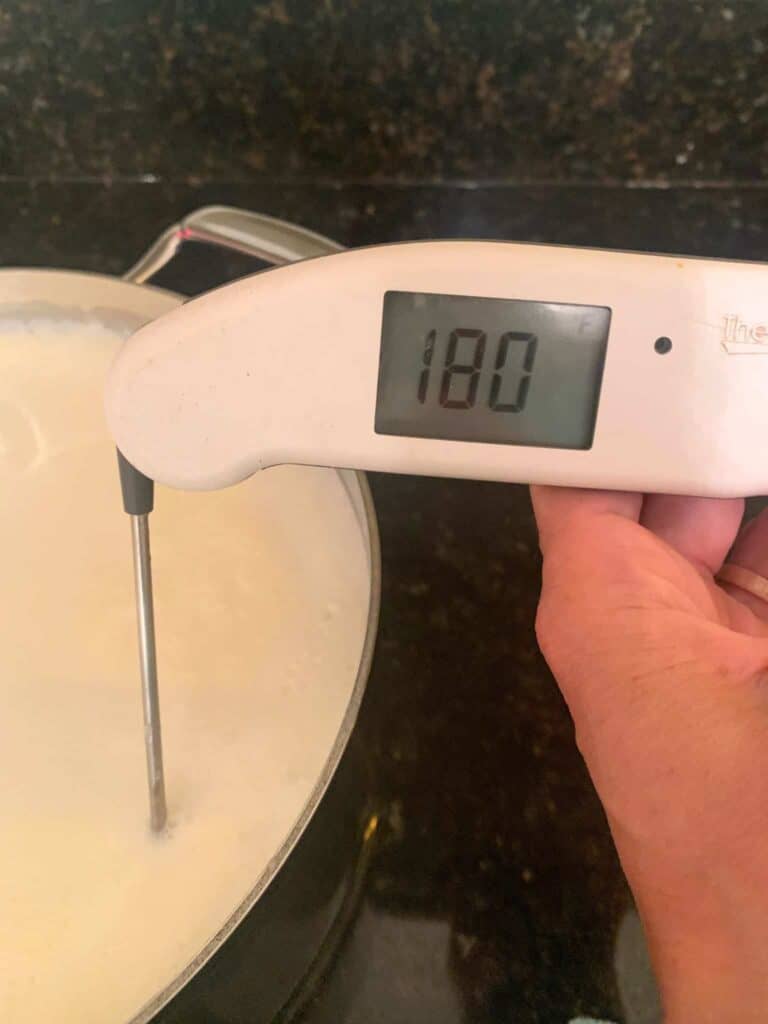 checking the temp of mlk with a digital thermometer