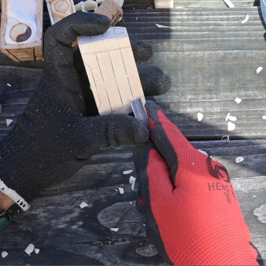 Using a V tool to add details on a wood carving