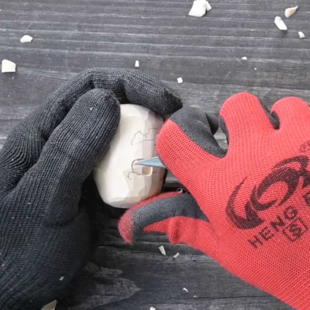 carving the eyes of a wood pupmkin