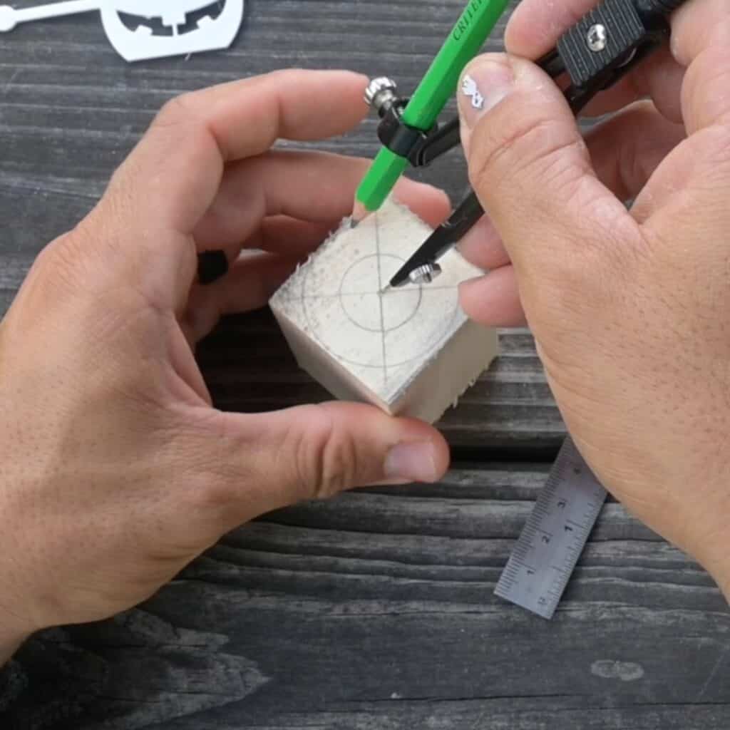 using a compass to draw circles on a block of wood