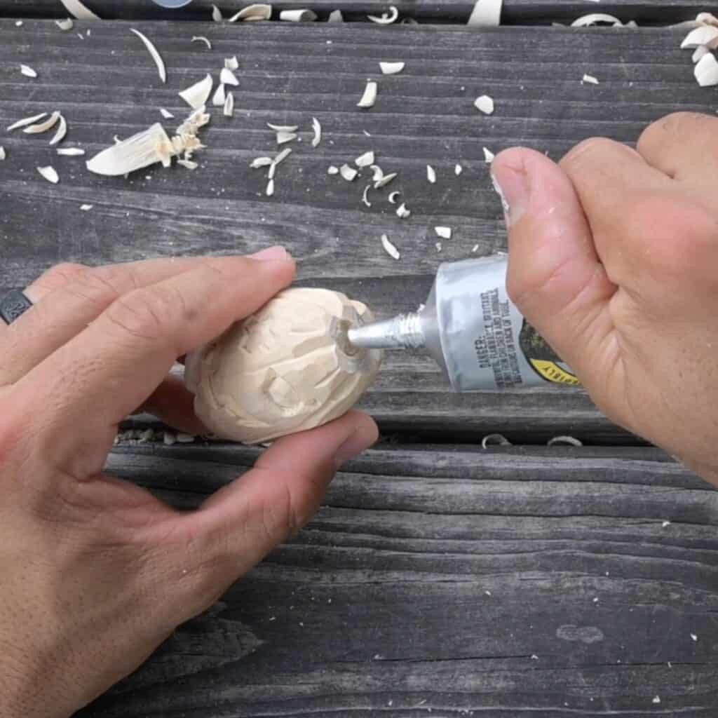 placing adhesive in a hole to add magnets