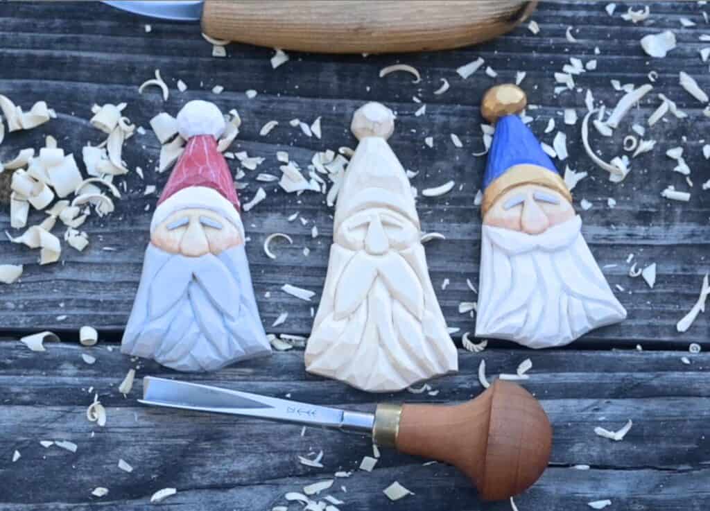 three wood carved santa ornaments