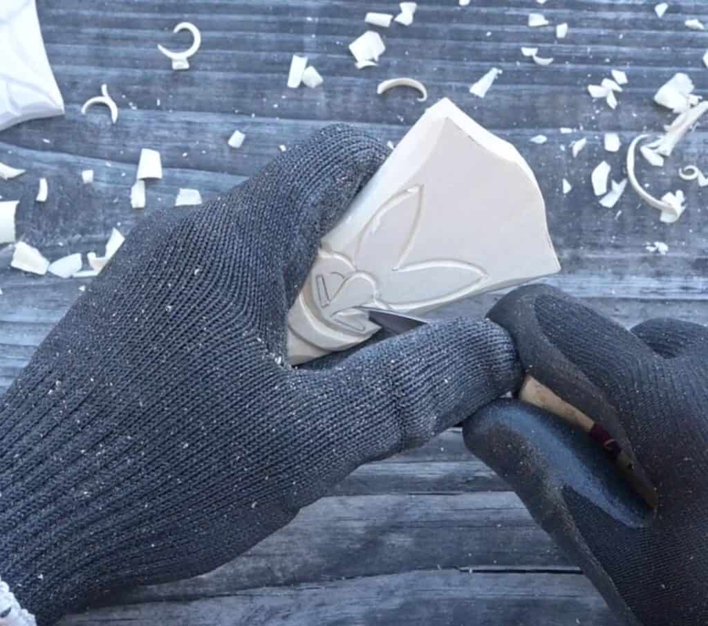 carving the eyes of a wood santa