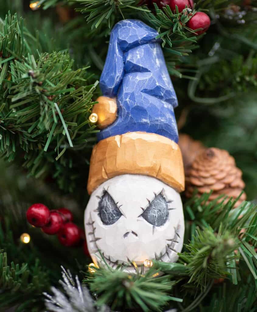 a spooky christmas ghost wood carving on a tree