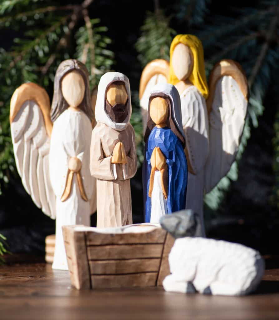 a wood carved Nativity set with angels